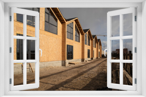 Fototapeta Naklejka Na Ścianę Okno 3D - Construction of a town houses from SIP panels.