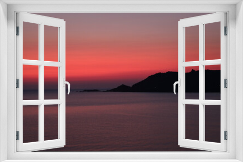 Fototapeta Naklejka Na Ścianę Okno 3D - warm tones of a fiery sunset with the island and the sea without people