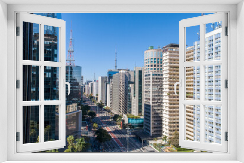 Fototapeta Naklejka Na Ścianę Okno 3D - Aerial view of Av. Paulista in São Paulo, SP. Main avenue of the capital. Sunday day, without cars, with people walking on the street