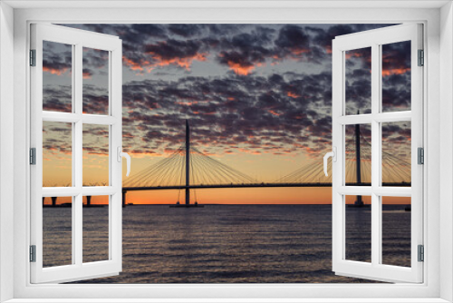 Fototapeta Naklejka Na Ścianę Okno 3D - View of the cable-stayed bridge and the bay at sunset