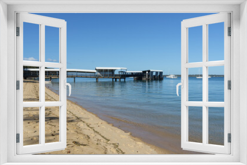 Fototapeta Naklejka Na Ścianę Okno 3D - View along the beach to Coochiemudlo Island jetty on a calm sunny day