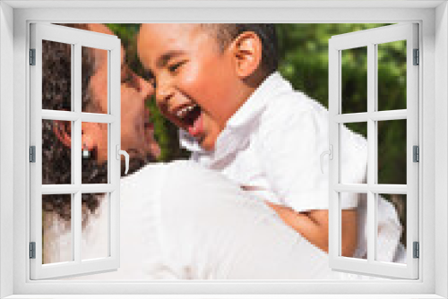 Latin mother and son having fun in the park.