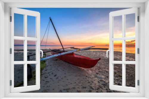 Fototapeta Naklejka Na Ścianę Okno 3D - a small boat on beach at sunrise