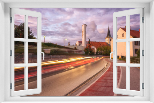 Fototapeta Naklejka Na Ścianę Okno 3D - Road with markings and tracers in the city before sunrise, Maribor, Slovenia. Scenic cityscape with european architecture and colored sky, outdoor travel background