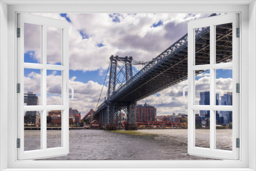 Fototapeta Naklejka Na Ścianę Okno 3D - A picture of Williamsburg Bridge in New York City, USA. In the picture one can see the East River and Manhattan skyline