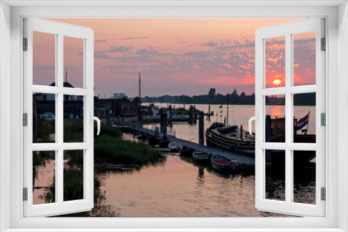 Fototapeta Naklejka Na Ścianę Okno 3D - The harbor from Woudrichem at sunset in the Netherlands