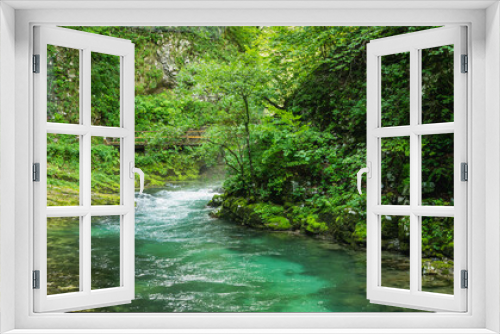 Fototapeta Naklejka Na Ścianę Okno 3D - Vintgar gorge, Slovenia. River near the Bled lake with wooden tourist paths, bridges above river and waterfalls. Hiking in the Triglav national park. Fresh nature, blue water in the forest.