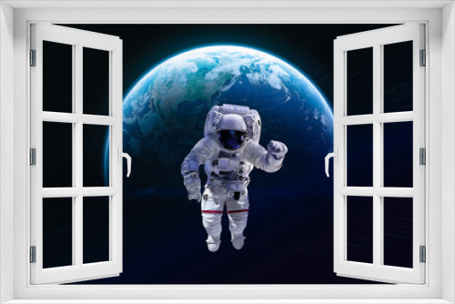 Fototapeta Naklejka Na Ścianę Okno 3D - Astronaut in outer deep space on orbit of Earth planet. Dark space and spaceman. Elements of this image furnished by NASA