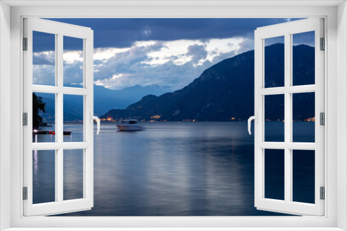Fototapeta Naklejka Na Ścianę Okno 3D - Night view of Lake Como and the cloudy mountains of Vasenna