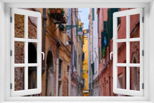 Fototapeta Naklejka Na Ścianę Okno 3D - Old narrow streets or calles of Venice, Italy. Medieval atmosphere, shabby and empty alleyways, UNESCO World heritage city.