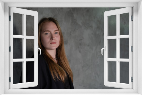 portrait of confident woman in black in dark room. pensive serious people. business woman. feminine. millennial people