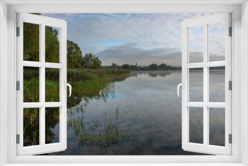 Fototapeta Naklejka Na Ścianę Okno 3D - Morning on the lake with the reflection of the sky and clouds