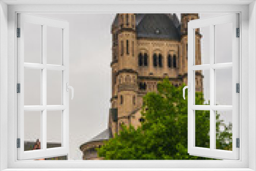 Fototapeta Naklejka Na Ścianę Okno 3D - Picturesque view of Cologne's Old Town, including the soaring crossing tower of the Great Saint Martin Church. The quadrangular tower, a landmark, has at each four corners another smaller tower.