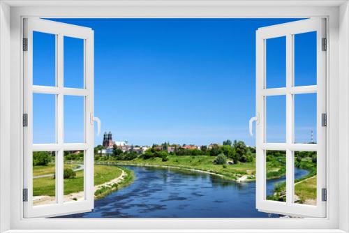 Fototapeta Naklejka Na Ścianę Okno 3D - the Warta River and bell towers of the historic Gothic cathedral