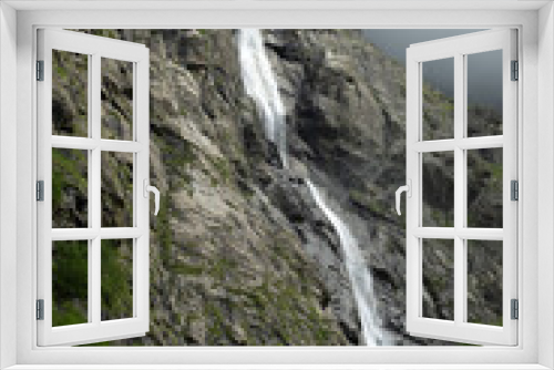 Fototapeta Naklejka Na Ścianę Okno 3D - Midagrabin waterfall in sunlight in cloudy summer weather. Caucasus mountains. Russia. North Ossetia Alania