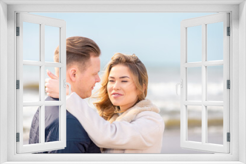 Two Young couple standing enjoying on a coast and enjoying each other.Summer,spring,autumn vacation.Closeup.