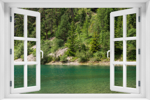 Fototapeta Naklejka Na Ścianę Okno 3D - a lakeshore of Blindsee lake with clear waters and surrounded by trees