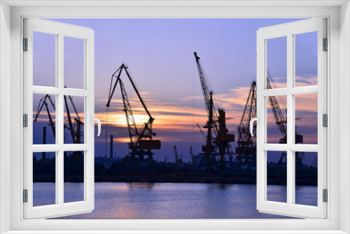 Fototapeta Naklejka Na Ścianę Okno 3D - Port cargo crane over sunset sky background
