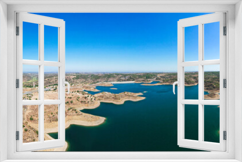 Fototapeta Naklejka Na Ścianę Okno 3D - The Odeleite Dam, located in the municipality of Castro Marim in the Algarve, was built on the River Odeleite, which rises in the uplands of the Serra do Caldeirão and flows into the Rio Guadiana