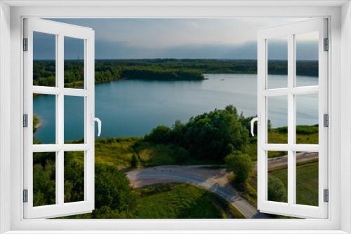 Fototapeta Naklejka Na Ścianę Okno 3D - Aerial view of a beautiful and dramatic sunset over a forest lake reflected in the water, landscape drone shot. Blakheide, Beerse, Belgium. High quality photo