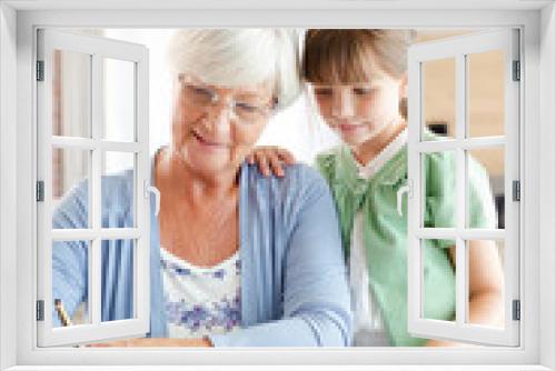 Older woman and granddaughter using calculator