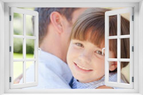 Father and daughter hugging outdoors