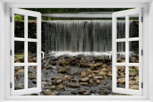 Fototapeta Naklejka Na Ścianę Okno 3D - Monroe, NY - USA - Aug. 28, 2021: Vertical view of the historic Dam and mill pond from Smith's Mill, located in center of the historic district in Monroe, NY