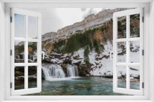 Fototapeta Naklejka Na Ścianę Okno 3D - River waterfall in a valley in a mountain river landscape in snowy winter, with trees in Ordesa Valley, Pyrenees, national park, Spain.
Horizontal view