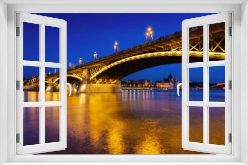 Fototapeta Naklejka Na Ścianę Okno 3D - View of bridges in Budapest, Hungary. Parliament building, bridges and the Danube River.  Classic blue hour photo.