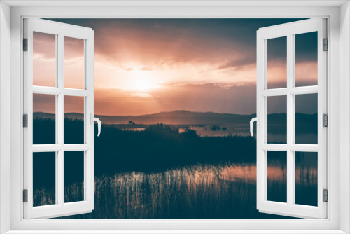Fototapeta Naklejka Na Ścianę Okno 3D - Sunset over a field of reeds. Fantastic landscape.