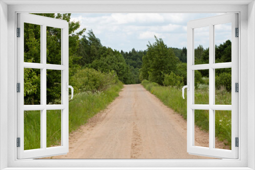 Fototapeta Naklejka Na Ścianę Okno 3D - A beautiful road outside the city. The road to freedom and fresh air