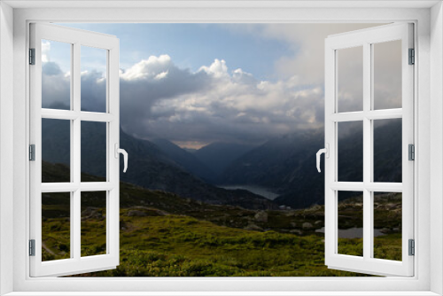 Fototapeta Naklejka Na Ścianę Okno 3D - Amazing Landscape in the hearth of Canton Bernese in Switzerland. Drive on the Grimselpass. Epic scenery with the clouds and fog. Wonderful sun rays through the clouds and later an amazing sunset.