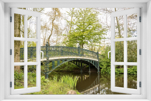 Fototapeta Naklejka Na Ścianę Okno 3D - Looking Out Over A River From A Blue Bridge