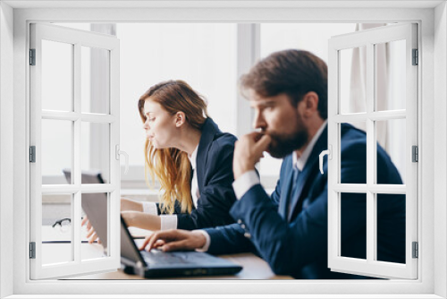 business man and woman sitting in front of a laptop teamwork internet officials