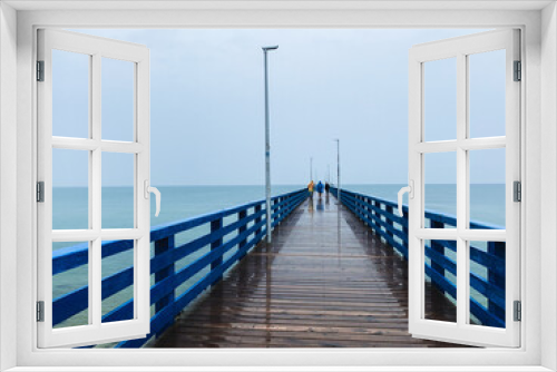 Fototapeta Naklejka Na Ścianę Okno 3D - Wooden pier in the sea, gray sky background, misty rainy day