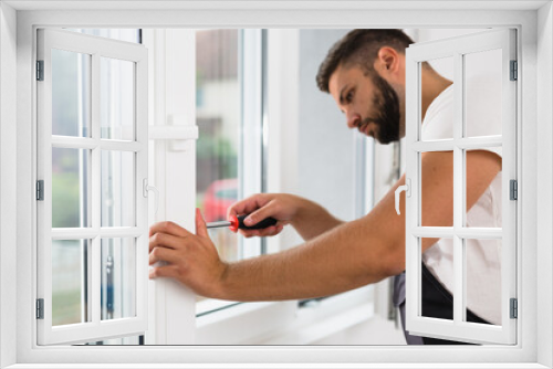 worker fixing pvc windows indoor