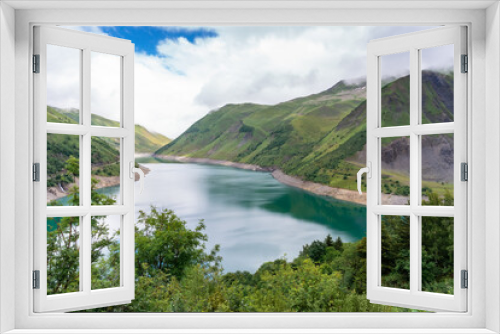 Fototapeta Naklejka Na Ścianę Okno 3D - Beautiful summer panorama of the mountain lake in Vaujany, France. Cloudy  view in the French Alps, Europe. Scenery landscape of high plateau.