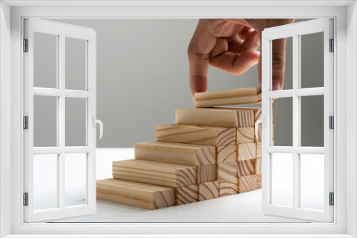 Fototapeta Naklejka Na Ścianę Okno 3D - Hand arranging wood block stacking as step stair or ladder career path concept for business growth success process