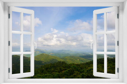 Spectacular view of a lush green mountains and beautiful clouds during monsoon. A scenic site from Munar, Kerala, India.