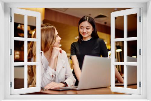 Multiracial cheerful young women smiling and looking at each other