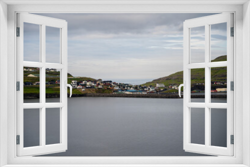 Fototapeta Naklejka Na Ścianę Okno 3D - Beautiful aerial view of the town of Miovagur in the Faroe Islands, with its :churchs, grass roofs and colorful Houses in front of the ocean 