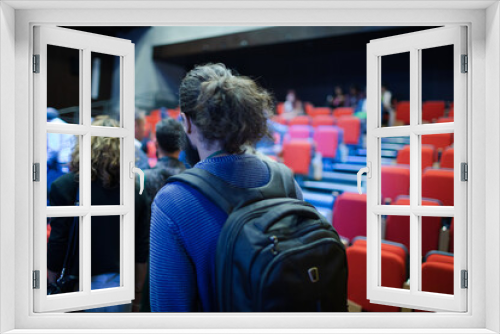 Audience arriving in auditorium