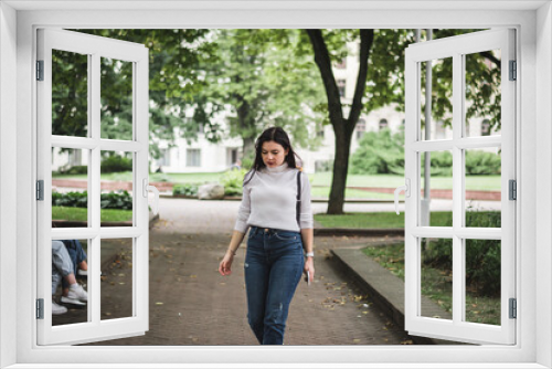 Stylish beautiful brunette girl in a summer city