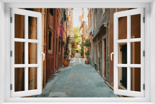 Fototapeta Naklejka Na Ścianę Okno 3D - Beautiful cozy narrow street in old town of Italy or Greece. Historic european facades of buildings. Cityscape concept.