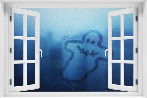 Fototapeta Naklejka Na Ścianę Okno 3D - cheerful ghost painted on glass of window on blue background