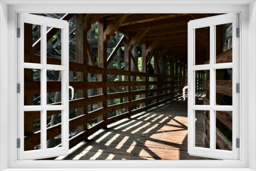 Fototapeta Naklejka Na Ścianę Okno 3D - A wooden bridge in the park