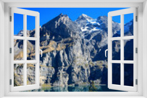 Fototapeta Naklejka Na Ścianę Okno 3D - Oeschinensee lake in Kandersteg, Switzerland. Panoramic view of the mountains and azure water on a clear sunny summer day. Popular tourist attraction.