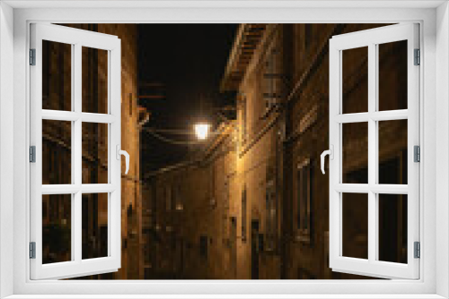 Fototapeta Naklejka Na Ścianę Okno 3D - old mediterranean alley at night in acquapendente, italy