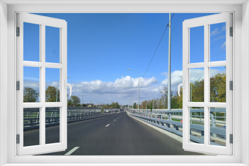Fototapeta Naklejka Na Ścianę Okno 3D - road with horizon on blue sky and clouds at daytime view from car.