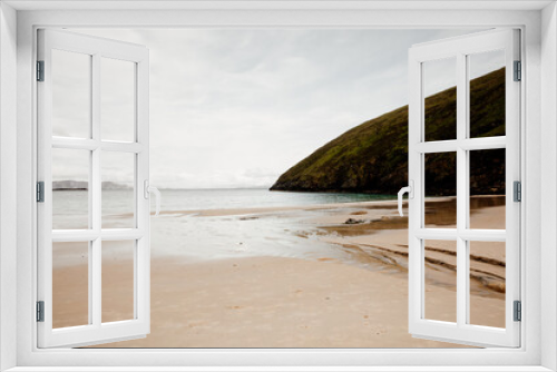 Fototapeta Naklejka Na Ścianę Okno 3D - Sandy beach in Ireland. Ocean view in Achill island, county Mayo. Beautiful landscape with ocean and hill. Overcast day, nobody on the beach. 